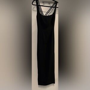 Black long zippered dress with side slit. Criss cross back.